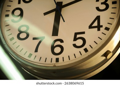 Close-up of an analog clock showing the time at 6:10, with hour and minute hands clearly visible.