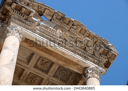 Close-up of an ancient column and classical temple, stone carvings of acanthus leaves and mythological motifs
