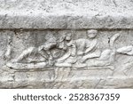 Close-up of an ancient stone relief from the Roman fortress of Sexaginta Prista in Ruse, Bulgaria, showcasing intricate carvings and historical art, ideal for cultural and archaeological themes.