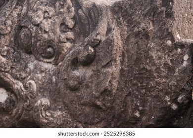 A close-up of an ancient stone relief showcasing intricate carvings, possibly depicting mythological creatures or symbols, rich in texture and historical significance - Powered by Shutterstock