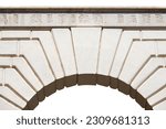 Closeup of an ancient white marble arch with keystone, isolated on white background.Full frame, photography. Brescia downtown, Lombardy, Italy, Europe.