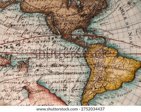 Close-up of an ancient world map featuring North and South America. Vintage style cartography on textured paper with handwritten calligraphic details.
