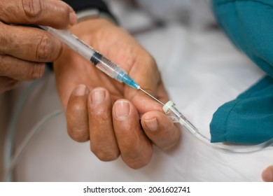 Closeup Of Anesthesiologist Putting Intravenous Medication To A Patient. General Anesthesia. Selective Focus