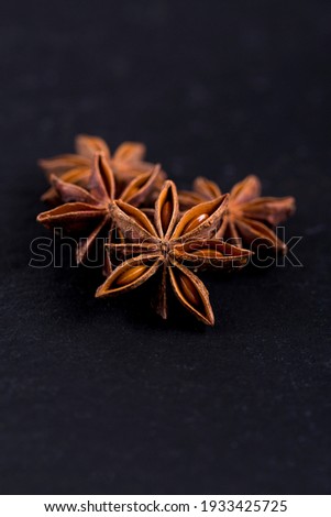 Close-up of aniseed stars on black background. Oriental cuisine ingredients: anise stars on a black background.