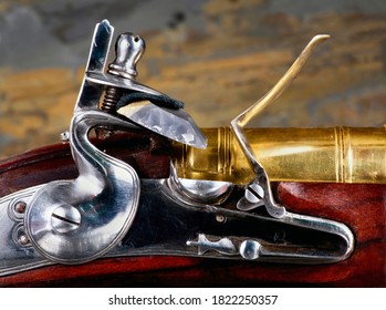 Closeup of antique flintlock gun showing the hammer ,flint , pan and frizzen. 