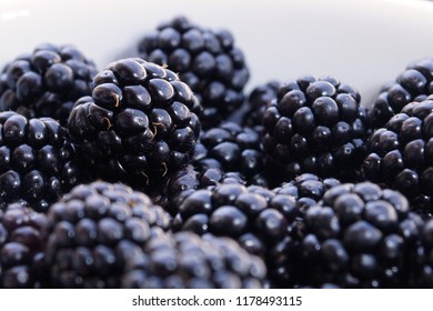 Close-up of appetizing blackberries on white background 