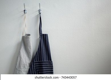 Close-up of aprons hanging on hook - Powered by Shutterstock