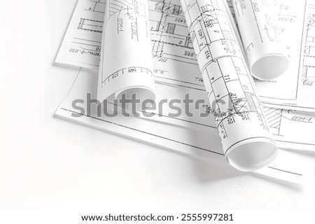 Close-up of architect  designer working construction blueprints planning building project.detailed drawings planning tools desk modern workspace. Perfectshowcasing professional project design architec