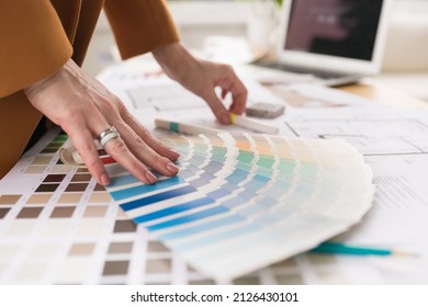 Close-up of architect woman choosing samples of wall paint. Interior designer looking at color swatch for creating project. House renovation, architecture and interior design concept. - Powered by Shutterstock