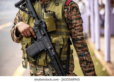 Close-up of a army man walking with automatic gun