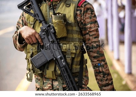 Close-up of a army man walking with automatic gun