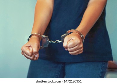 Close-up. Arrested Woman Handcuffed Hands. Prisoner Or Arrested Terrorist, Hacker, Bribetaker, Close-up Of Hands In Handcuff.