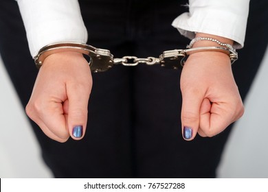 Close-up. Arrested Woman Handcuffed Hands At The Back. Prisoner Or Arrested Terrorist, Close-up Of Hands In Handcuffs