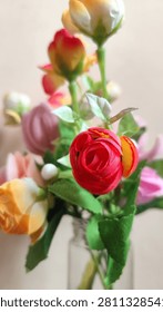 Close-Up of Artificial Red Rose with Soft Bokeh Floral Background