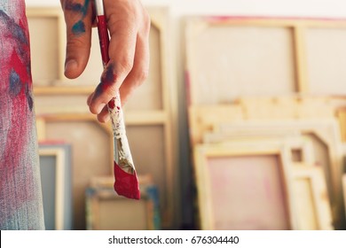 Closeup Of An Artist Holding Paintbrush