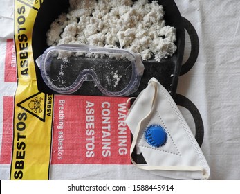 Closeup asbestos and fibers, mask, filter and goggles. Asbestos bag in the background. Barrier tape, warning forbidden acces hazard. Asbestos removal. Asbestosis, lungcancer or mesothelioma, serie.