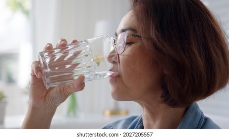 Close-up Asia Elder People Or Latin Lady Hold Clean Spring Cold Alkaline Water In Hand Drink Sip Joy Relax Help Aging Face Skin Benefit For Female, Routine Life Balance Weight Loss By Nature Taste.