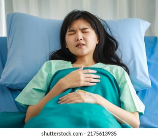 Close-up Of Asian Female Patient Lying On Hospital Bed, Covered With Soft Blanket, Sleeping Tiredly After Having Medical Treatment And Be Given An IV Drip