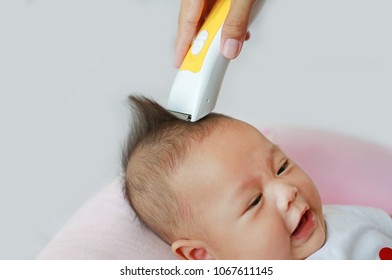 Closeup Asian infant baby boy getting a haircut.