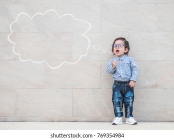 Closeup asian kid say something action with text box on marble stone wall textured background with copy space