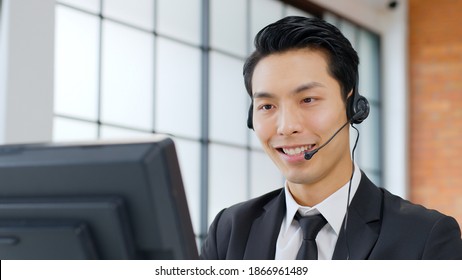 Closeup Asian Man Call Center, Customer Service, Telesales In Formal Suit Wearing Headset Or Headphone Talking With Customer In Modern Office