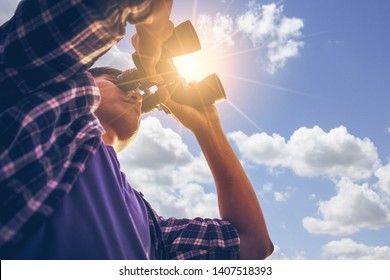 Close-up Of Asian man Hand Holding / looking / watching using Binoculars with copyspace, Technology Binoculars background concept