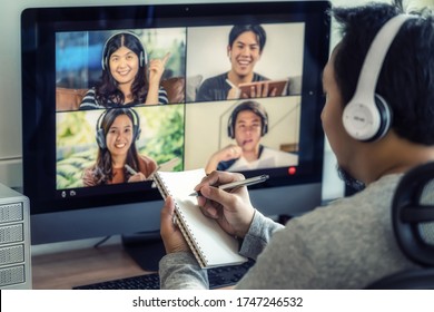 Closeup Asian Man Hand Writing Notebook When Online Learning Via Video Conference With Colleague And Team Building Meeting When Covid-19 Pandemic,Coronavirus Outbreak,online Meeting,new Normal Concept