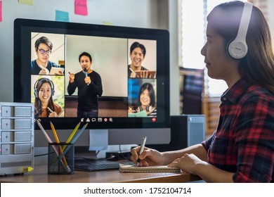 Closeup Asian Woman Hand Writing Lecture When Online Learning Via Video Conference With Teacher Or Speaker With Colleague When Covid-19 Pandemic, Coronavirus Outbreak,online Meeting,new Normal Concept