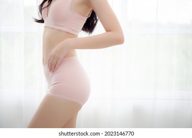 Closeup asian woman wear underwear beautiful body belly slim shape sexy with diet at room, model asia girl wear bra hand touch abdomen thin with weight loss, health and wellness concept.