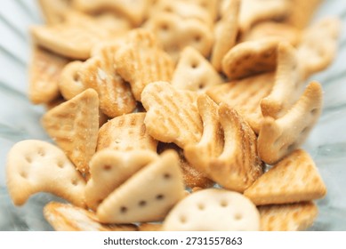 Close-up of assorted crackers shaped in fun and whimsical shapes in a glass bowl.