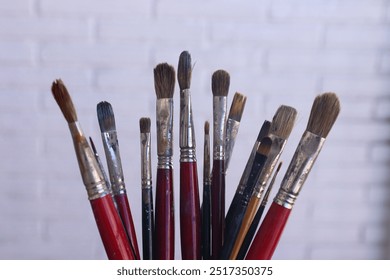 Close-Up of Assorted Paintbrushes – Essential Tools for Artists and Creative Professionals - Powered by Shutterstock