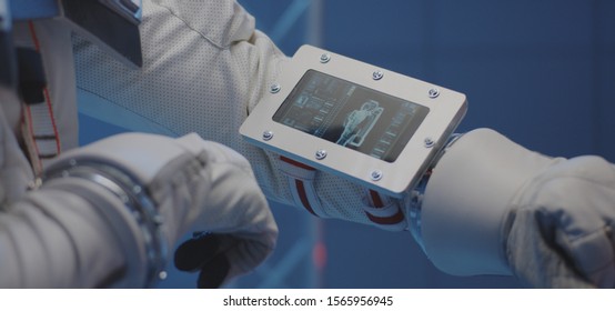 Close-up Of An Astronaut Using A Wrist Computer