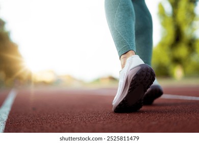 Closeup of athlete female feet in running shoes jogging on the athlete  track - Powered by Shutterstock