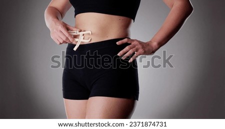Close-up Of A Athlete Person Measuring Her Body Fat With Caliper In The Gym