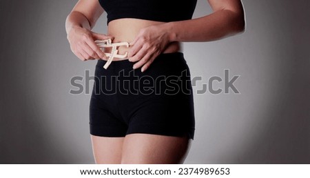 Close-up Of A Athlete Person Measuring Her Body Fat With Caliper In The Gym