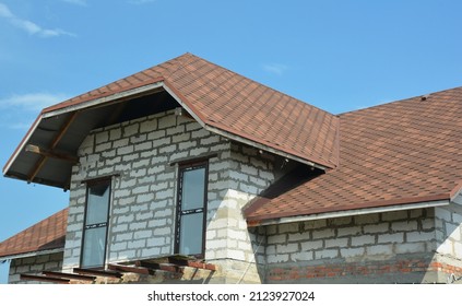 A Close-up Of An Attic Of One And A Half Storey House Under Construction With Dormer Windows, Asphalt Shingled Roof, And The Beginning Of A Loft Balcony Construction.Asphalt Shingles Roofing.