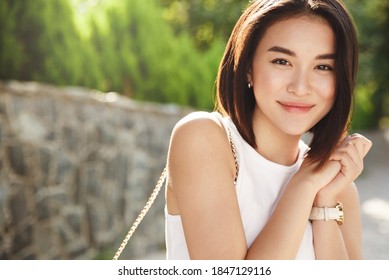 Close-up Attractive Asian Woman Smiling At Camera, Walking In Park. Modern Girl Looking Happy While Walking Down The Street On Sunny Summer Day.