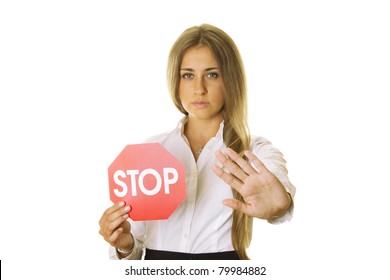 Close-up of an attractive young business woman in one hand a STOP sign, the other shows STOP gesture. isolated