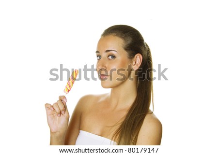Close-up of an attractive young woman with a bright candy. Isolated on a white background