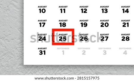 Close-up of August 25th date marked with a red cursor on a 2026 wall calendar