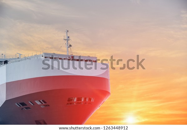 Closeup of Auto car\
carrier ship, logistics and transportation of international, on\
sunset background.