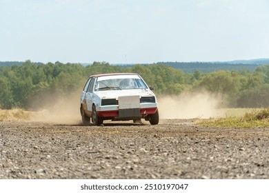 A close-up of an autocross racing car. Clouds of dust and sand burst out from under the wheels. Off-road racing. - Powered by Shutterstock