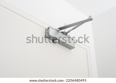 Closeup of an automatic door closer