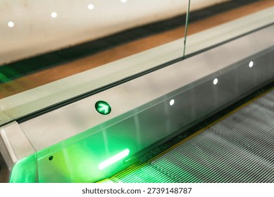 Close-up at automatic escalator pathway during it moving. Transportation equipment with object, selective focus.