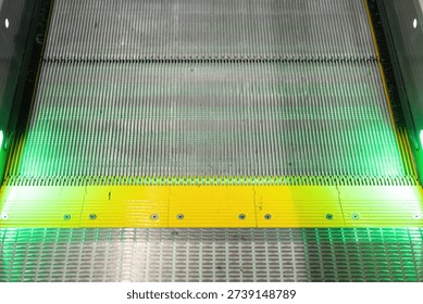 Close-up at automatic escalator pathway during it moving. Transportation equipment with object, selective focus.