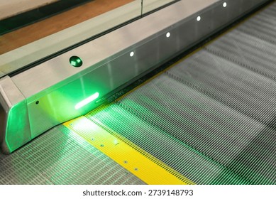 Close-up at automatic escalator pathway during it moving. Transportation equipment with object, selective focus.