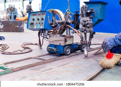 Close-up of automatic submerged arc welding (SAW) taken on thick metal sheets.