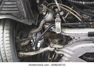 Close-up of automotive front suspension parts.