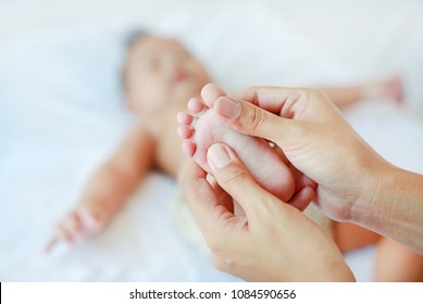 Close-up Baby Foot Massage On The Bed.