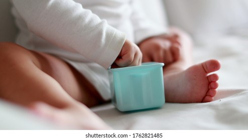 
Close-up Baby Hands Grabbing Empty Box After Finishing Food Snack